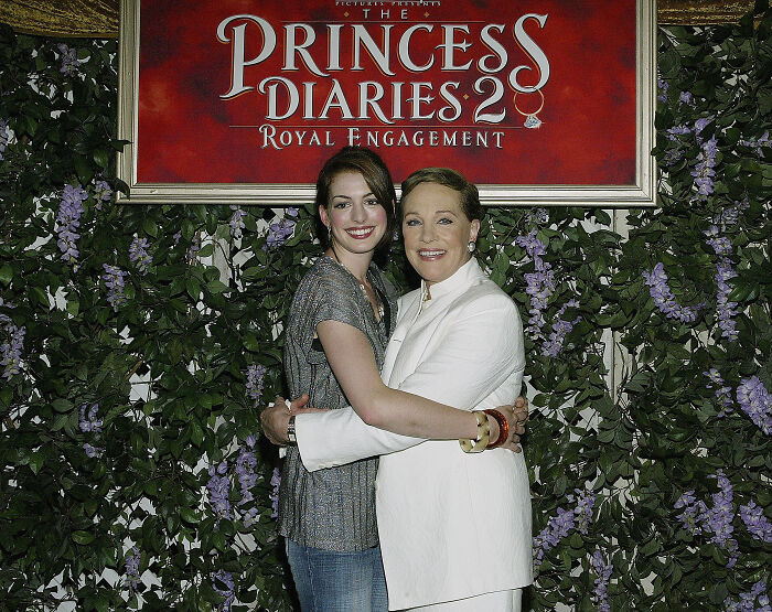 Anne Hathaway and legendary actress Julie Andrews hugging at The Princess Diaries 2 event. Anne Hathaway and legendary actress Julie Andrews hugging at The Princess Diaries 2 event.
