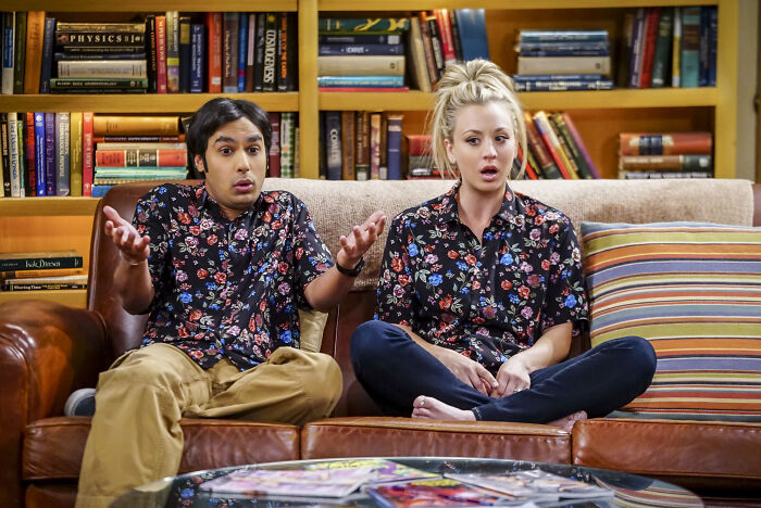 Kaley Cuoco and Raj from The Big Bang Theory, sitting on a couch, reacting to a scene. Kaley Cuoco and Raj from The Big Bang Theory, sitting on a couch, reacting to a scene.