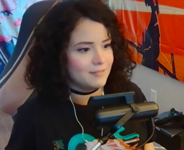 Old photo of the goth baddie before her transformation, smiling and wearing a choker. Old photo of the goth baddie before her transformation, smiling and wearing a choker.