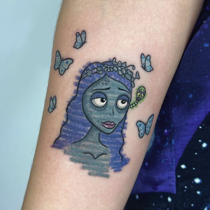Striking Corpse Bride tattoo surrounded by butterflies, in a crayon drawing style, displaying childhood creativity.