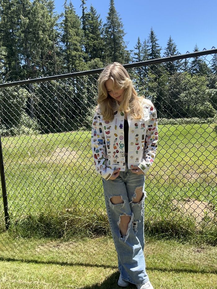Young woman standing in a garden wearing a jacket featuring Gen-Z pop culture patches