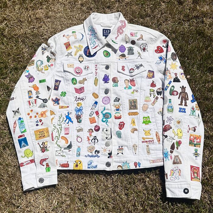 A white denim jacket covered in various pop culture pins and patches, showcasing Gen-Z childhood nostalgia.