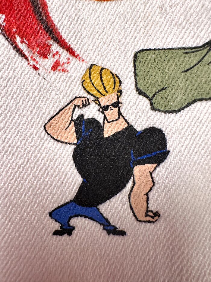 Detailed image of Johnny Bravo, a pop culture character that shaped Gen-Z's childhood, on a jacket.