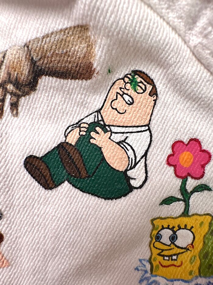 A close-up of a pop culture jacket featuring Peter Griffin and Spongebob characters, reflecting Gen-Z childhood.
