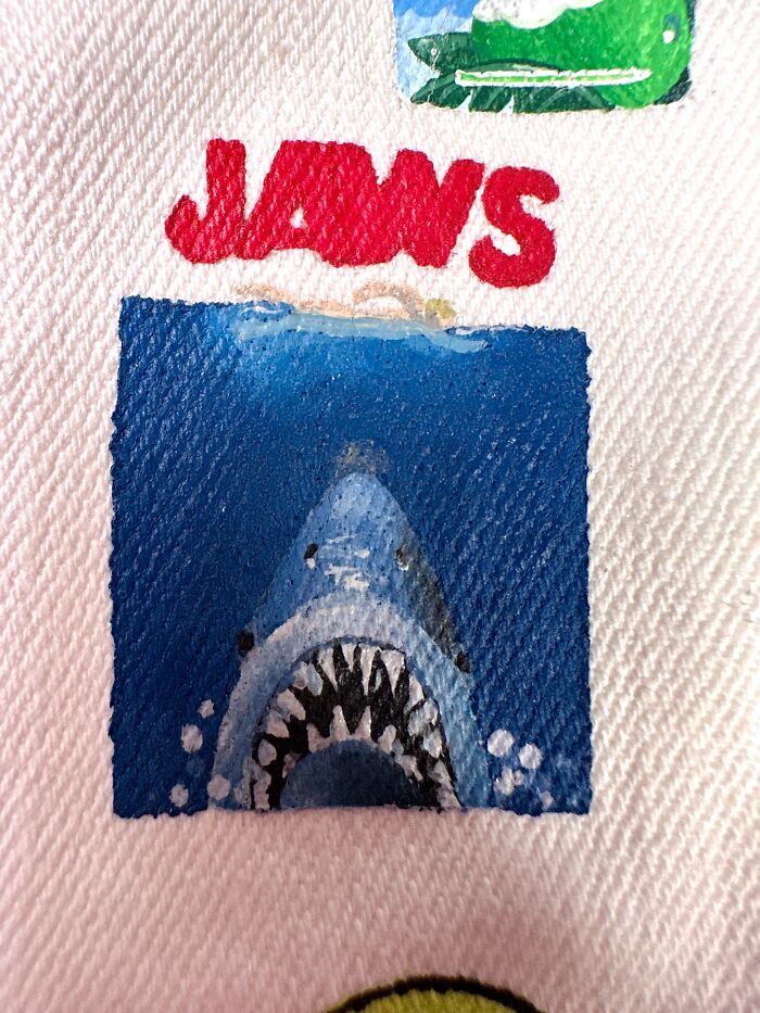 Jaws movie poster detail on a pop culture jacket. This jacket shows pop culture that shaped Gen-Z's childhood.