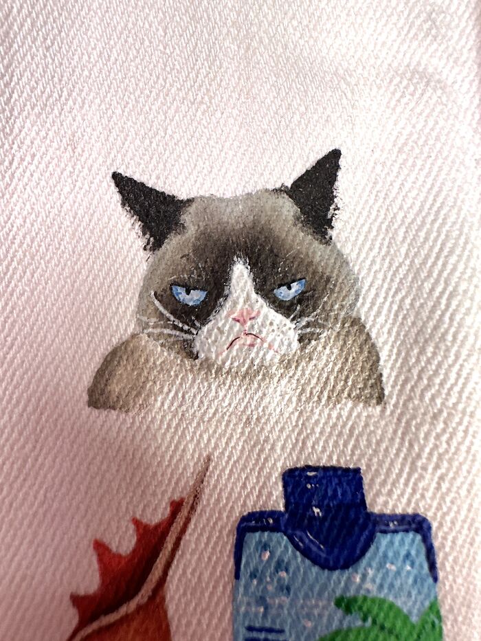 Grumpy Cat artwork, representing pop culture that shaped Gen-Z's childhood, painted on a jacket.