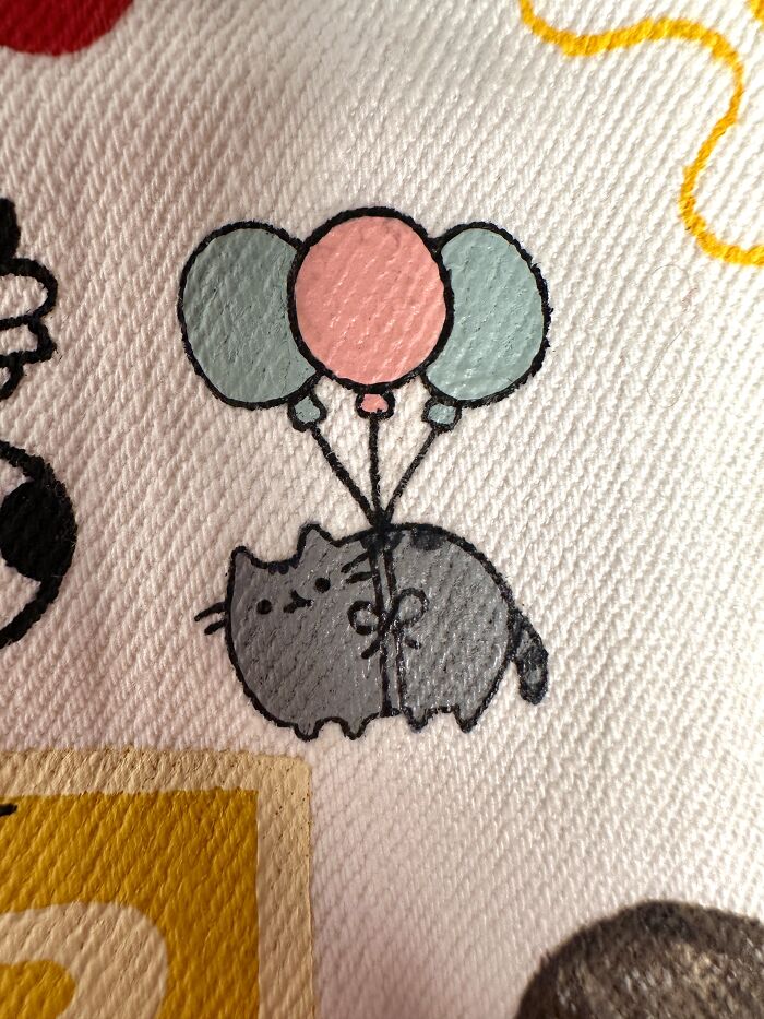 Pusheen cat with balloons detail on a pop culture jacket. This jacket shows pop culture that shaped Gen-Z's childhood.