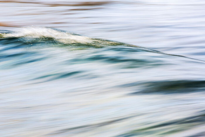 Blurred motion photo of a gentle wave in blue-green water, a stunning photo from the nature photography festival.