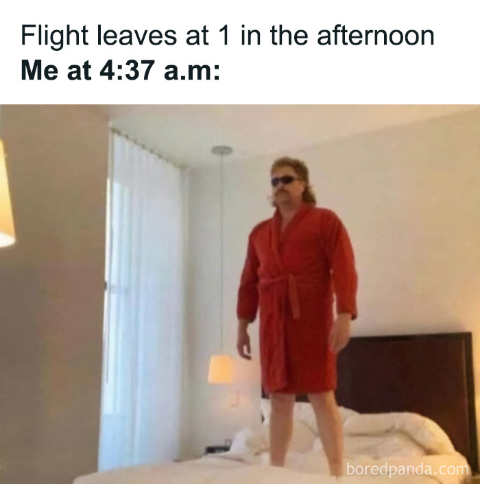A man in a red robe standing on a bed early in the morning, ready for a flight, a common travel meme.