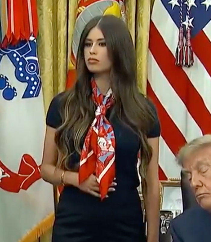 A cropped image of the mystery woman behind Trump with a strange gesture, sparking a wild theory. A cropped image of the mystery woman behind Trump with a strange gesture, sparking a wild theory.