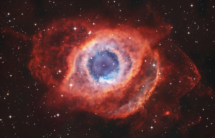 The Helix Nebula, a red and blue cosmic eye.