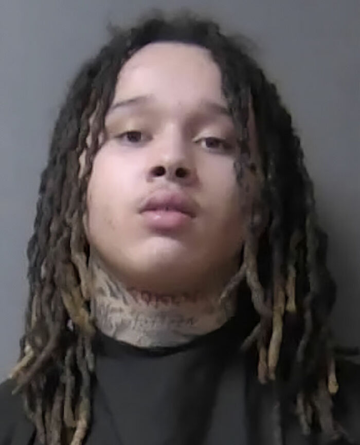 A young man with dreadlocks and neck tattoos, facing 100 years in prison. A young man with dreadlocks and neck tattoos, facing 100 years in prison.