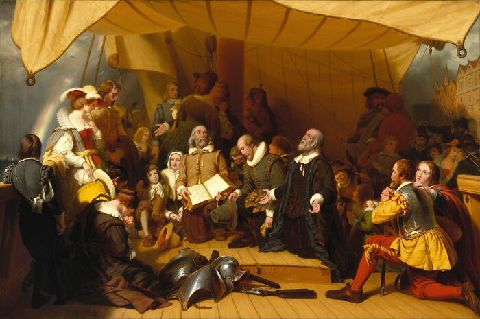 A painting of Pilgrims on a ship, praying, with a rainbow in the background, depicting religious misconceptions.