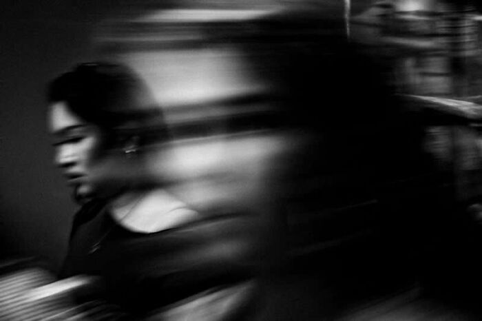 Blurred black and white street photography of a woman in motion, a mesmerizing winning photo from the LensCulture Awards.