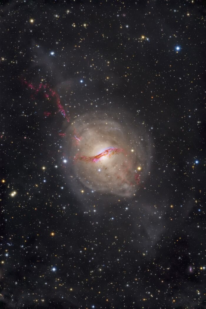 An awe-inspiring astrophotography image showcasing a spiral galaxy with red cosmic dust, among the David Malin Astrophotography Awards.