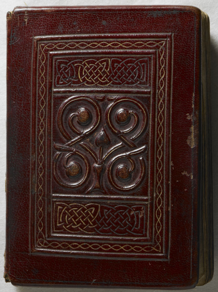Antique leather-bound book with embossed design, a historical document among famous books and manuscripts that sold for millions.