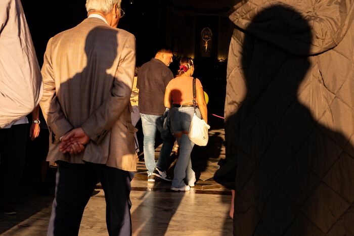 A candid moment of people walking, captured by street photography. This image portrays authentic moments of urban life.