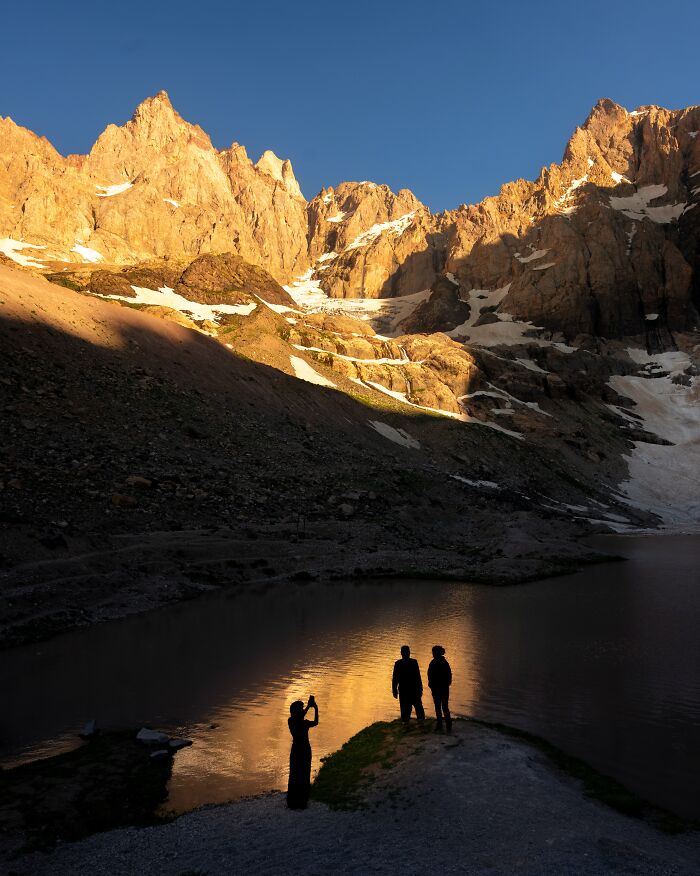 Murat Bakmaz captures the easily missed beauty of people silhouetted against a mountain lake at sunset.