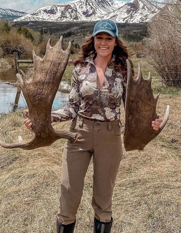 Smiling woman holds large moose antlers, highlighting the US tourist's court fate for a snatched baby wombat. Smiling woman holds large moose antlers, highlighting the US tourist's court fate for a snatched baby wombat.