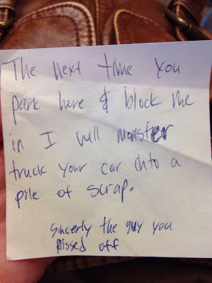 A handwritten note threatening to monster truck a car if it continues to block parking. Jerk neighbors and parking.