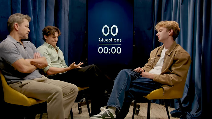 Matt Damon and Tom Holland engaged in a discussion with another actor, showcasing great actors. Matt Damon and Tom Holland engaged in a discussion with another actor, showcasing great actors.