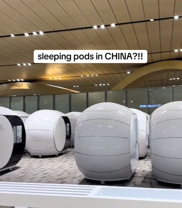 A cluster of futuristic sleeping pods in a Chinese airport, ready for travelers to rest. A cluster of futuristic sleeping pods in a Chinese airport, ready for travelers to rest.