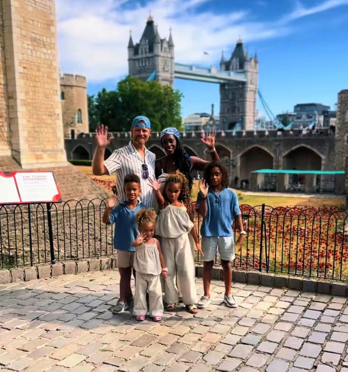 A happy family with kids, posing in front of Tower Bridge in London on a sunny morning. A happy family with kids, posing in front of Tower Bridge in London on a sunny morning.