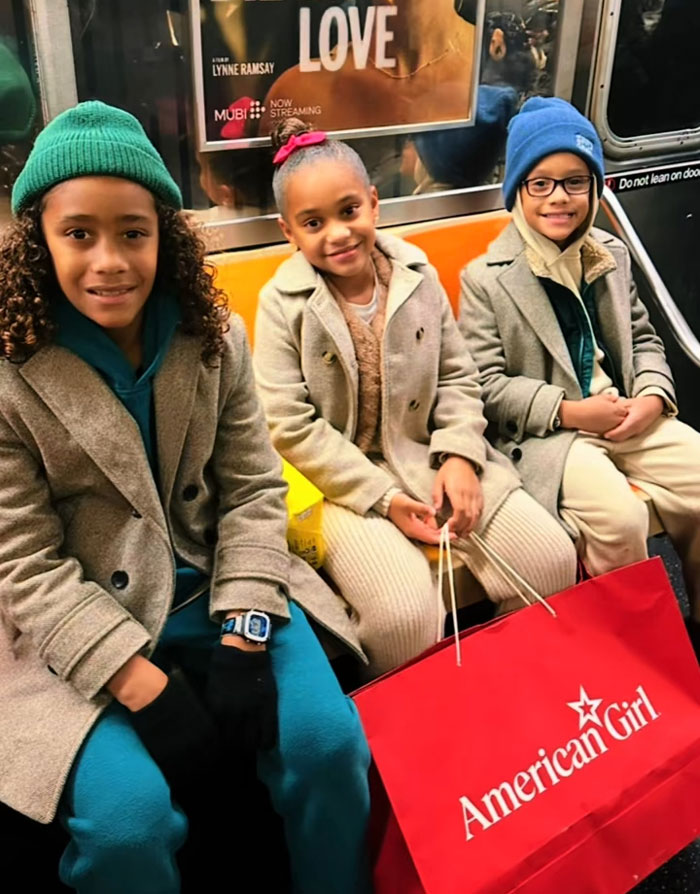 Three kids on a subway with an American Girl bag, reflecting kids spending mornings reading and exercising. Three kids on a subway with an American Girl bag, reflecting kids spending mornings reading and exercising.