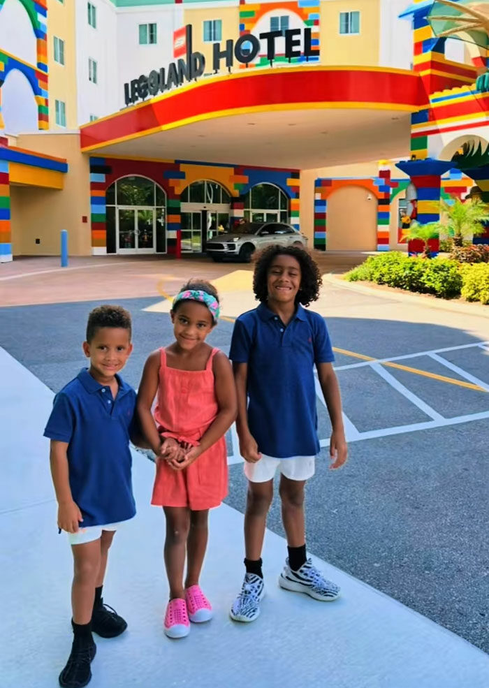Three happy kids in front of the Legoland Hotel, ready for a fun day of play and exercising. Three happy kids in front of the Legoland Hotel, ready for a fun day of play and exercising.