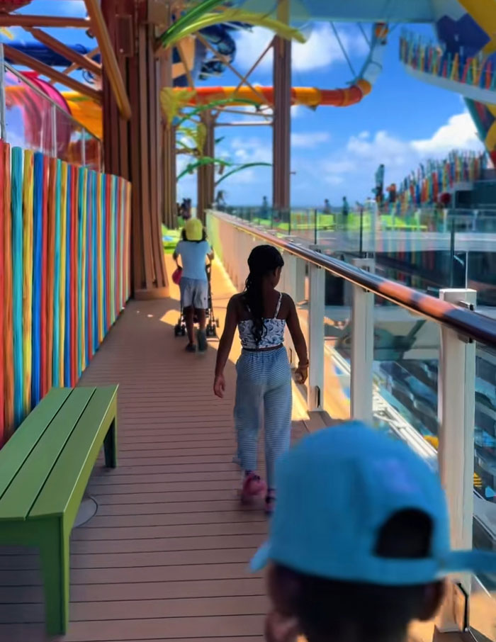 Two kids walking on a colorful deck at a resort, showcasing a lifestyle of spending mornings reading and exercising. Two kids walking on a colorful deck at a resort, showcasing a lifestyle of spending mornings reading and exercising.