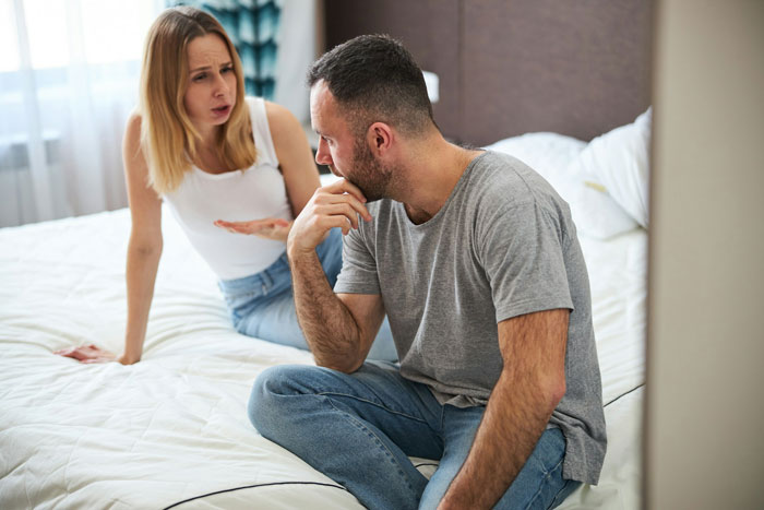 A distressed couple on a bed, the wife cheats on husband, making ludicrous demands in a heated discussion. A distressed couple on a bed, the wife cheats on husband, making ludicrous demands in a heated discussion.