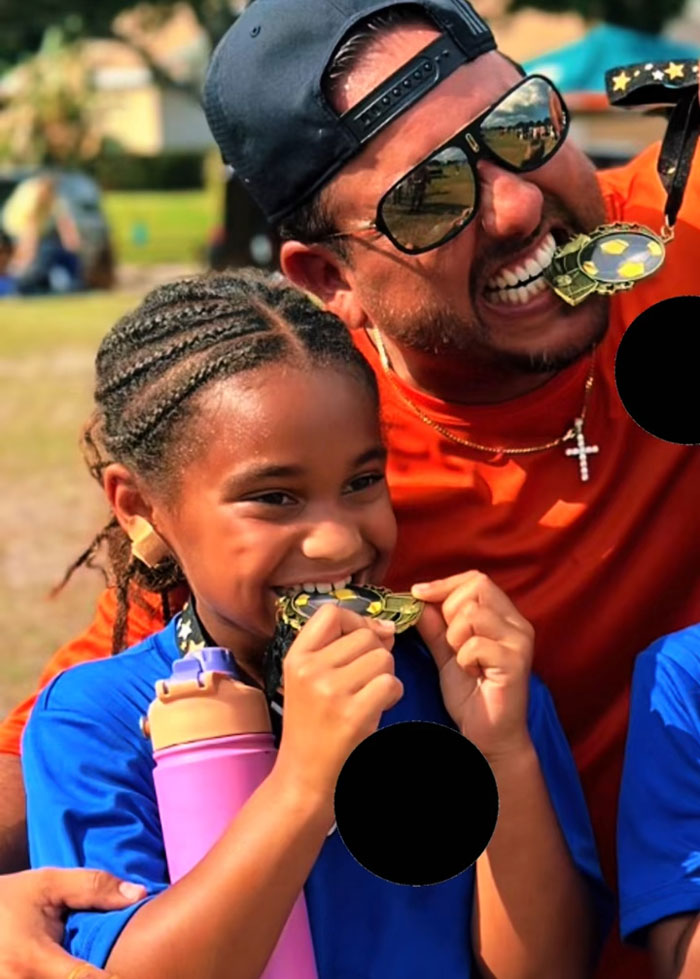 A father and daughter biting their sports medals, proud of kids exercising and achieving results. A father and daughter biting their sports medals, proud of kids exercising and achieving results.