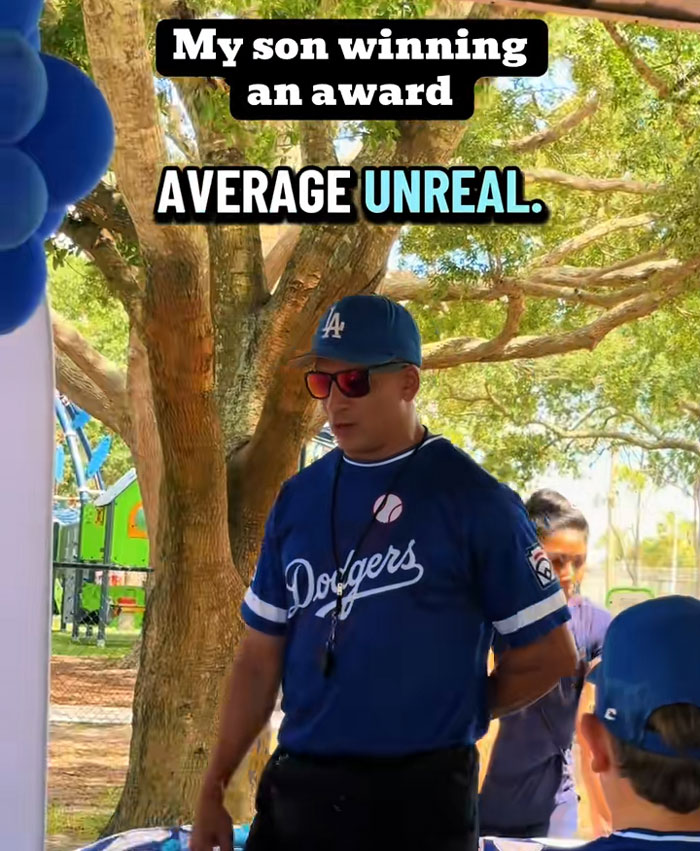 A father in a Dodgers jersey at an outdoor event, celebrating his son winning an award for kids results. A father in a Dodgers jersey at an outdoor event, celebrating his son winning an award for kids results.