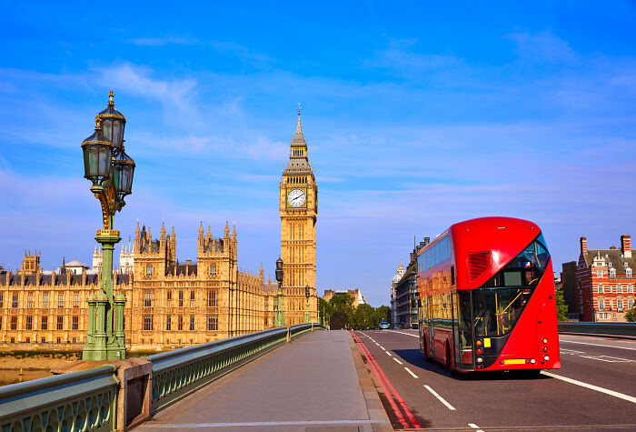 Absurd American questions: a red double-decker bus on a bridge in London with Big Ben.