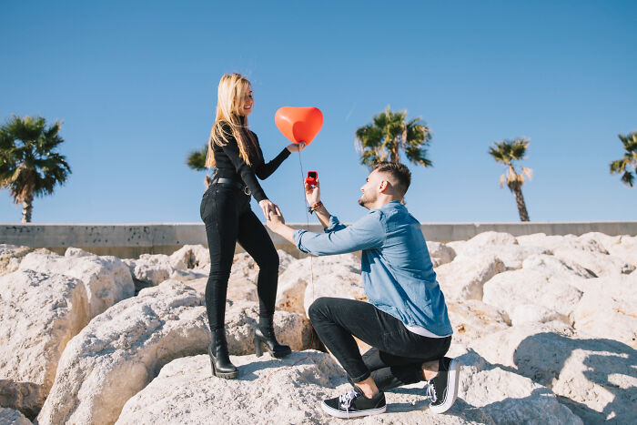 An American man proposing to a European woman, highlighting cultural differences and absurd questions.