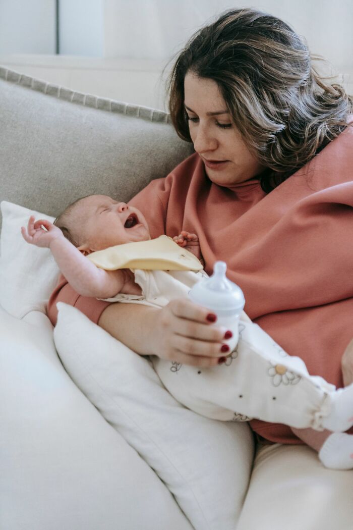 A mother comforting a crying baby, highlighting the seriousness of not speaking to others over ridiculous reasons.