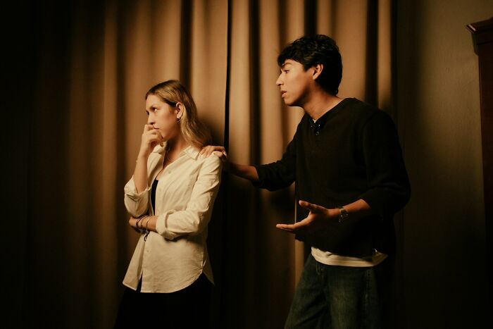 A man talking to a woman, trying to reconcile after not speaking for years over ridiculous reasons.
