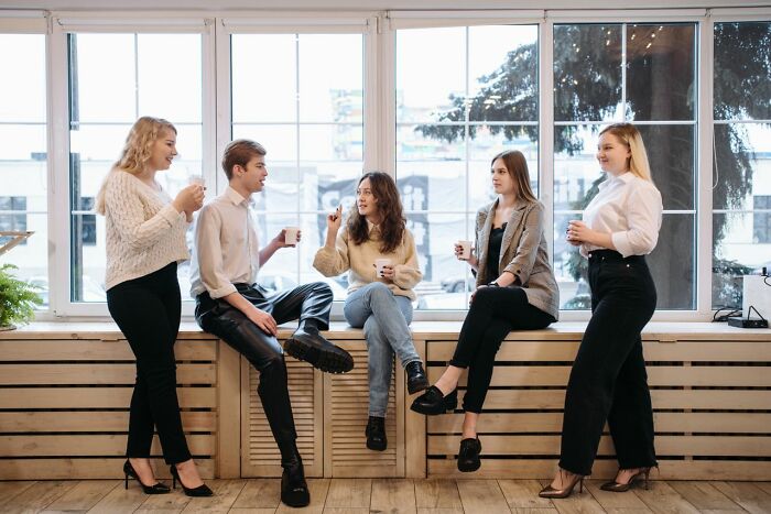 A diverse group of friends chatting happily, contrasting with those not speaking for ridiculous reasons.