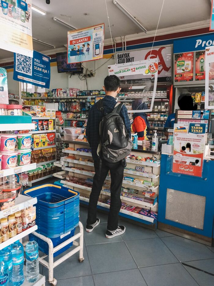 A man with a backpack in an aisle of a convenience store, revealing ridiculous reasons people see red.