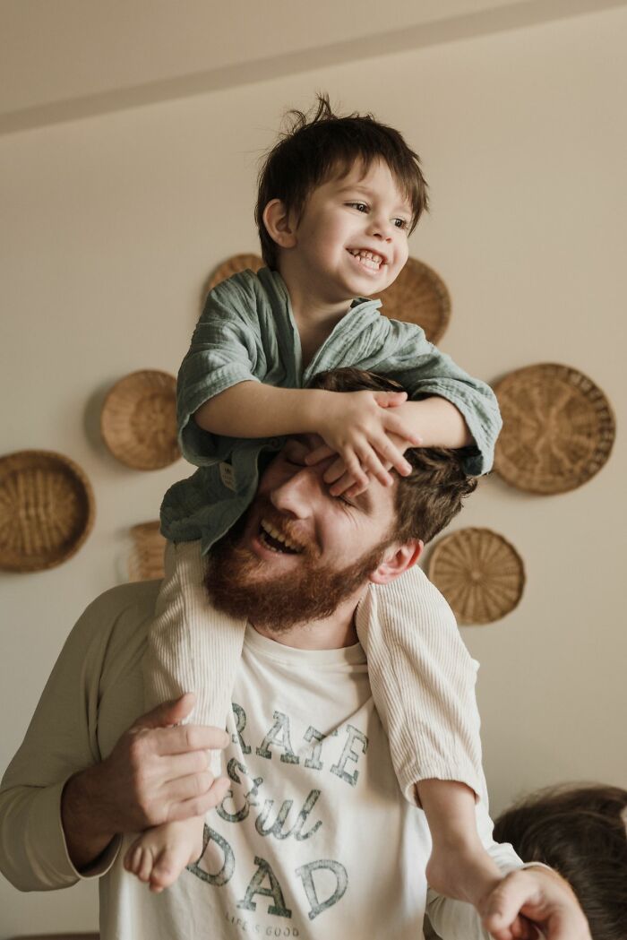 A father and son laughing, with the boy on his dad's shoulders, illustrating ridiculous reasons for seeing red.