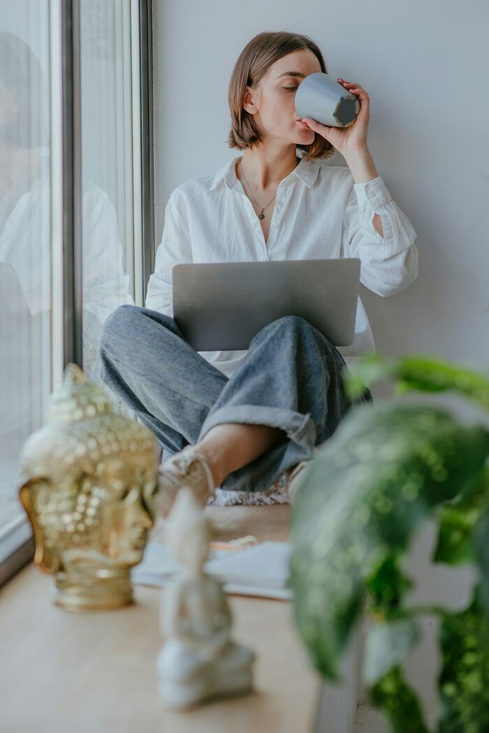 A woman drinking coffee, illustrating a moment of quiet after a dispute or ridiculous reasons.