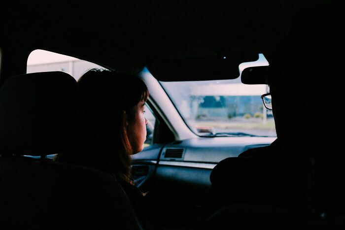 Inside a car, a customer looks out the window at a drive-through, possibly about to say crazy things to an employee.