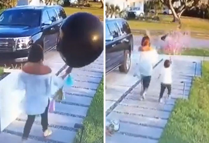 A parent holding a large black balloon with a child, a common scene many parents experience.