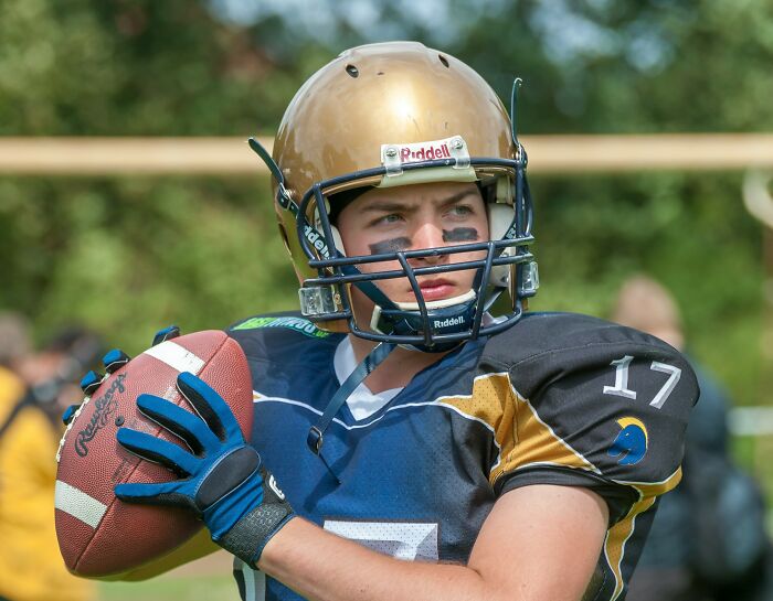 A football player in a gold helmet holds a football, representing things doctors refuse to do.