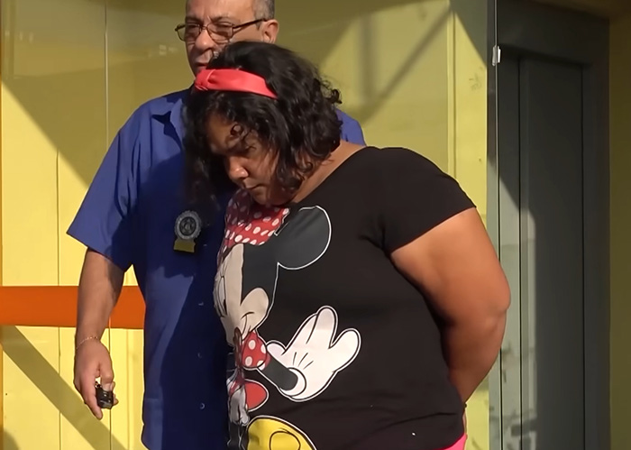 The 38-year-old woman, who tricked a kind couple, being escorted, learning her fate in court.