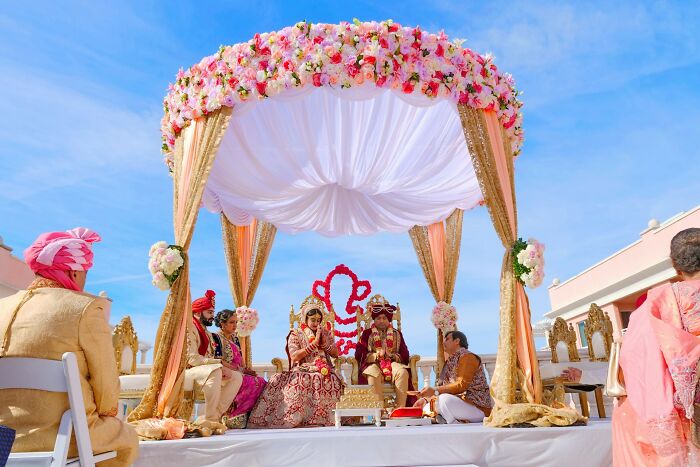 An elaborate outdoor Indian wedding ceremony, showcasing various wedding moments.
