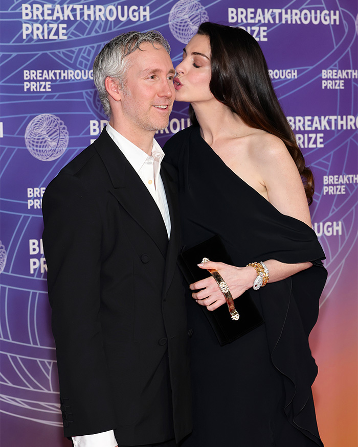 Anne Hathaway's red carpet maternity outfit with her husband, sparking pregnancy theories.