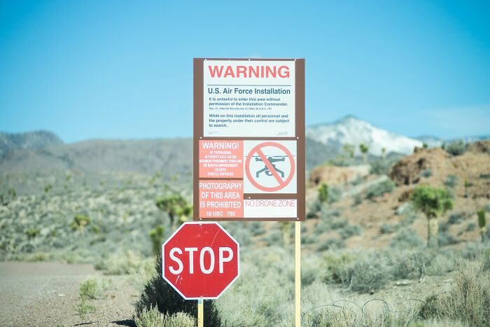 A warning sign outside Area 51, prohibiting entry and drone usage, reinforcing its status as a highly restricted military installation, not related to aliens. A warning sign outside Area 51, prohibiting entry and drone usage, reinforcing its status as a highly restricted military installation, not related to aliens.