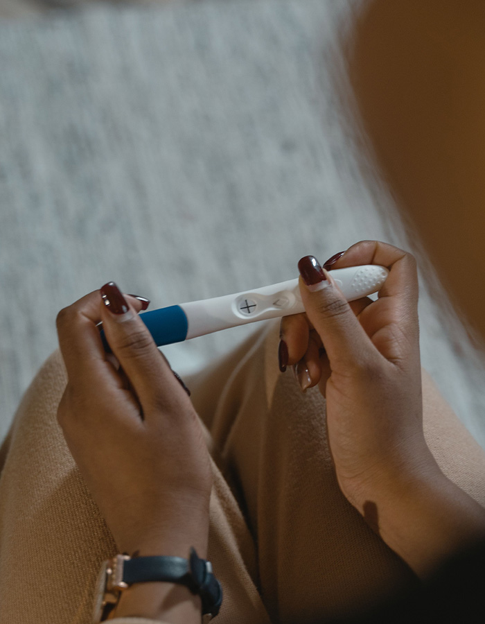 A woman holding a positive pregnancy test, representing the baby canceled decision. A woman holding a positive pregnancy test, representing the baby canceled decision.