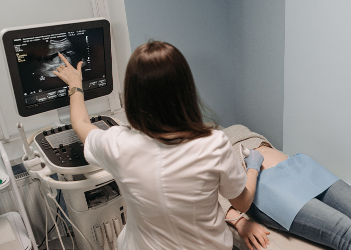 A doctor performing an ultrasound on a pregnant woman, related to the baby canceled narrative. A doctor performing an ultrasound on a pregnant woman, related to the baby canceled narrative.